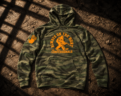 Camouflage On The Hunt pullover hoodie with orange Bigfoot graphic, “Always on the Hunt” text and sleeve handprint.